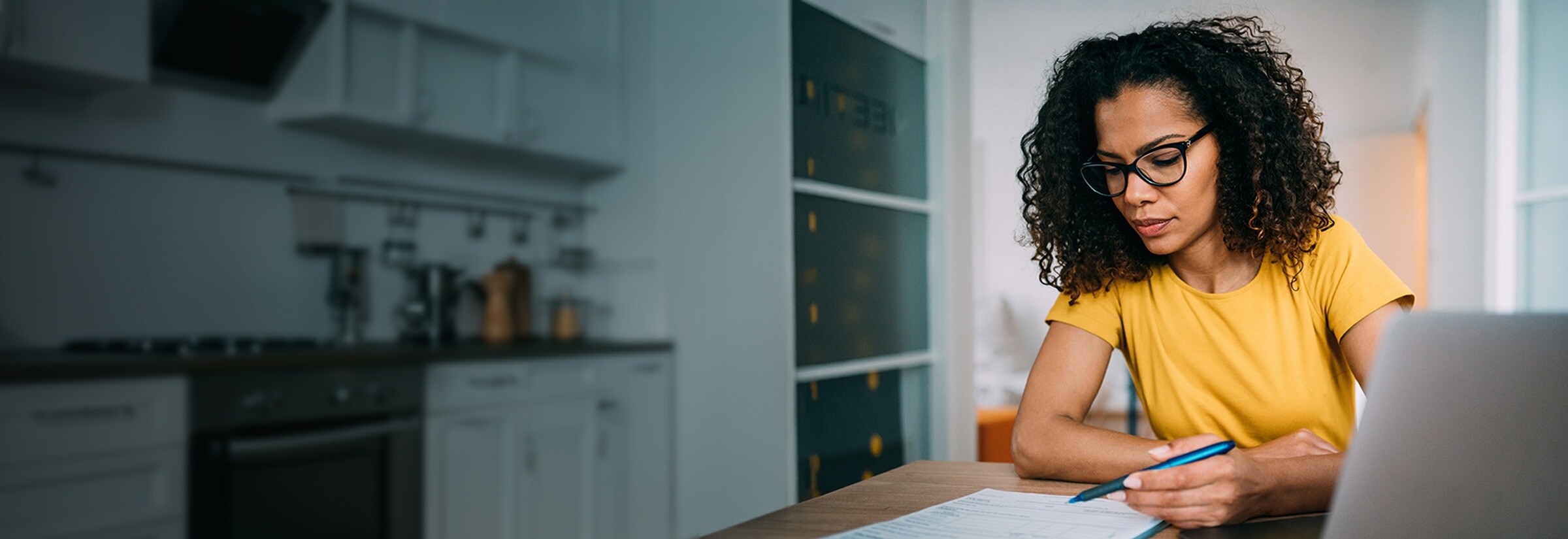 A person fills out their tax return early to avoid potential tax fraud.